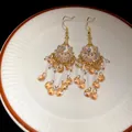 Detail of bohemian tassel earrings with rhinestones, pearls and orange glass beads - Hook Tassel Style / Gold