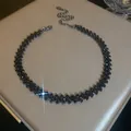 Detailed view of a sparkling black rhinestone geometric choker on a luxury jewelry box. - 18# Necklace - Eco-friendly - Black