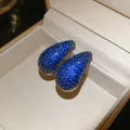 Close-up of teardrop stud earrings fully encrusted with vibrant blue zircons - 7# Blue Teardrop Pave Zirconia (Silver Post)