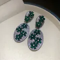 Macro detail of emerald green flower earrings with shimmering white zircon stones - 10# Emerald Oval Flower (Silver Post)