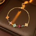 Elegant gold chain bracelet featuring colorful zircon flower charms for women - Multicolored (Gold Plated)
