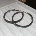 Macro detail of elegant gunmetal hoop earrings encrusted with shimmering black zircon stones - 19# Black Pave Large Hoop (Silver Post)