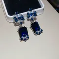Close-up of vintage butterfly earrings with large sapphire-blue rectangular gemstones - 36# Deep Blue Flower Butterfly Dangle (Silver Post)