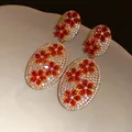 Close-up of vintage gold earrings with white pavé zircons and red floral patterns - 45# Gold Red Flower Pave Oval (Silver Post)
