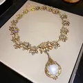 Vintage gold floral necklace with a large pear-shaped pearl and crystal accents. - Rhinestone Flower Artificial Pearl Pendant Necklace (2#)