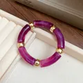 Detailed close-up of a purple marbled acrylic bracelet with elegant gold spacers - Purple