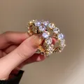 Orecchini a cerchio dorati di lusso decorati con scintillanti zirconi rotondi - Stile Strass Bianco Tondo