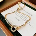 Detailed macro shot of adjustable gold bracelet with sparkling crystal paved circle - Rhinestone Circle Style / Gold