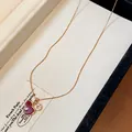 Close-up detail of a red enamel gourd necklace with zircon pendant inside a jewelry box - Gourd Pendant / Gold-Red