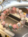 Handmade colorful ceramic beaded bracelet featuring pink and green floral patterns. - Red Green Floral Pattern Beads (35 Bracelet)