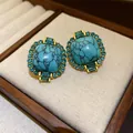 Macro view of vintage silver needle stud earrings with marbled blue turquoise - Gold-Blue