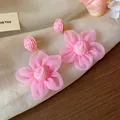 Macro detail of sweet pink chiffon floral earrings with woven raffia texture. - Pink Floral (HE30843)