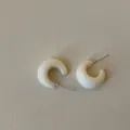 Detail shot of white flocking C-shaped stud earrings with silver pins for women - C-Shape Flocked Style / White