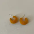 Macro detail view of mustard yellow flocking C-shape stud earrings with silver needles - C-Shape Flocked Style / Yellow