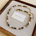 Detailed close-up showing the intricate shell and stone beads of this ethnic style necklace - Necklace (HN5942-1) / Gold Brown