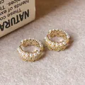 Close-up of elegant gold lace hoop earrings with pearls and crystals - Ear Buckle / Gold