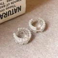Detailed view of silver lace hoop earrings with delicate pearl accents and scalloped edges. - Ear Buckle / Silver