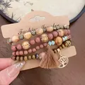 Detailed view of bohemian beaded bracelet set with tree of life charm and tassel - Four-Piece Set / Brown