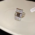 Close-up of square zircon ring featuring a central S logo and chain band - Square Chain Splicing Style (WR491) / Silver