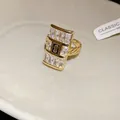Macro view of gold chain ring featuring a rectangular zircon pavé and central 'S' detail. - Square Chain Splicing Style (WR492) / Gold