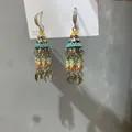 Close-up detail of Bohemian style tassel earrings with colorful glass beads and silver leaf charms - Leaf Tassel Ear Hook / Gold