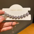Close-up view of elegant heart-shaped zircon bracelet on a white display card - Heart Zircon Style