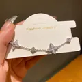 Close-up of a silver flower bracelet with sparkling zircons on a display card - Flower Style