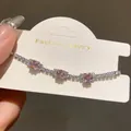 Detail shot of a silver bracelet featuring square pink stones and clear zircon accents. - Square Zirconia Style