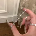 Close-up detail of exquisite silver fleur-de-lis cross bracelet with sparkling zircons - Fleur-de-lis Cross Style (WB1142) / Silver