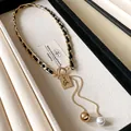 Collier vintage chaîne entrelacée de cuir avec pendentif Oui et perle. - Or