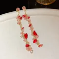 Detail shot of elegant long tassel earrings featuring pink and red crystal stones - Tassel Drop Style (HE25074) / Gold Pink Gradient