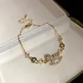 Close-up of 14k gold plated bracelet with sparkling zircon rocking horse pendant - Rocking Horse Pendant Bracelet / Gold