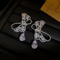 Exquisite silver zircon butterfly drop earrings featuring a shimmering teardrop pendant - Stud Earrings / Silver