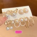 Close-up of five pairs of elegant pearl and gold-finished earring set on a display card - 5# Silver Post Style