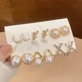 Detailed view of six pairs of elegant pearl and crystal earrings on a white card - 16# Silver Needle Style