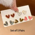 Detail view of five pairs of colorful heart-shaped oil-drop stud earrings on white card - 21# Silver Needle Style