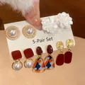 Close-up detail of 5-pair elegant earring set featuring pearls and white floral designs - 23# Silver Needle Style