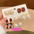 Close-up of a 5-pair set of French vintage pearl and enamel earrings on a card - 24# Silver Needle Style
