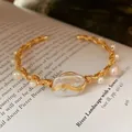Elegant handmade wire-wrapped gold bangle featuring a natural baroque freshwater pearl - Hand Wire Wrapped Baroque Pearl Cuff Bangle Style (15)