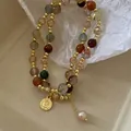 Close-up of baroque pearl and crystal double-layer bracelet with a gold coin charm - Double Layer Style / Gold