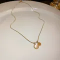 Close-up detail of a delicate gold chain necklace with cat-eye stone and disc pendants - Round Cat's Eye Style (4#)