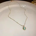Close-up of elegant gold necklace featuring an oval light green cat's eye stone pendant - Oval Cat's Eye Style (3#)