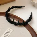 Detailed close-up view of a black acrylic headband with irregular stone embellishments. - Irregular Crushed Stone Style / Black