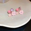Detailed macro view of sweet pink floral earrings with purple geometric crystals on a plate - Floral Cat's Eye (17#) / Pink / Silver Needle