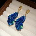 Detail of vintage irregular dangle earrings with blue crystalline resin pendant - Blue