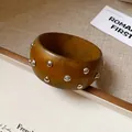 Κοντινό πλάνο vintage ξύλινου βραχιολιού με ασημί μεταλλικά καρφιά - Διακόσμηση με Πριτσίνια (38#)