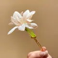 Detail view of a delicate pink fabric lily flower hairpin with water droplets - Hair Stick Gold-Pink / Pink