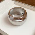 Close-up of chunky polished silver metal cuff bracelet with a spring hinge detail - Large Bracelet / Silver