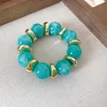 Dettaglio del bracciale in acrilico marmorizzato con distanziatori in metallo dorato - Bead Splicing (HB4541) / Blu Lago