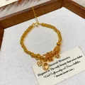 Detail shot of a gold-plated beaded bracelet with elegant flower and stone charms. - Gold Floral Stone Style (2#)